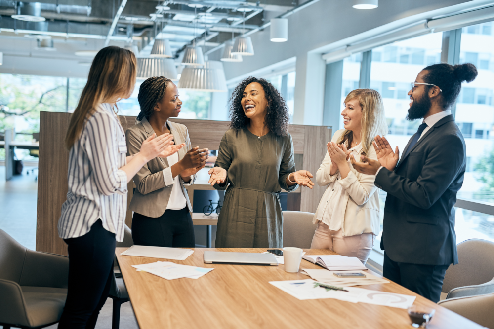 Employees collaborate and engage happily at work, fostering a positive workplace culture that prioritizes teamwork, communication, and employee satisfaction.