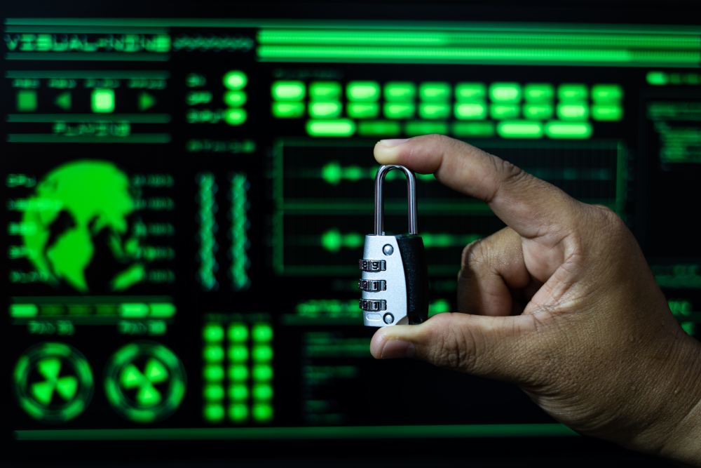 An individual holding a lock in front of a cybersecurity screen displaying data protection information, symbolizing secure access and data safety.