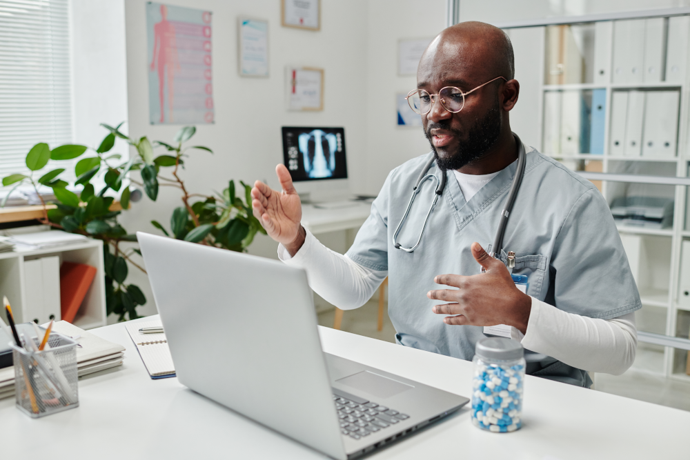 Doctor conducting a telehealth appointment with a patient using a mobile device. The image illustrates the use of telehealth technology in healthcare, providing accessible medical services remotely to patients.